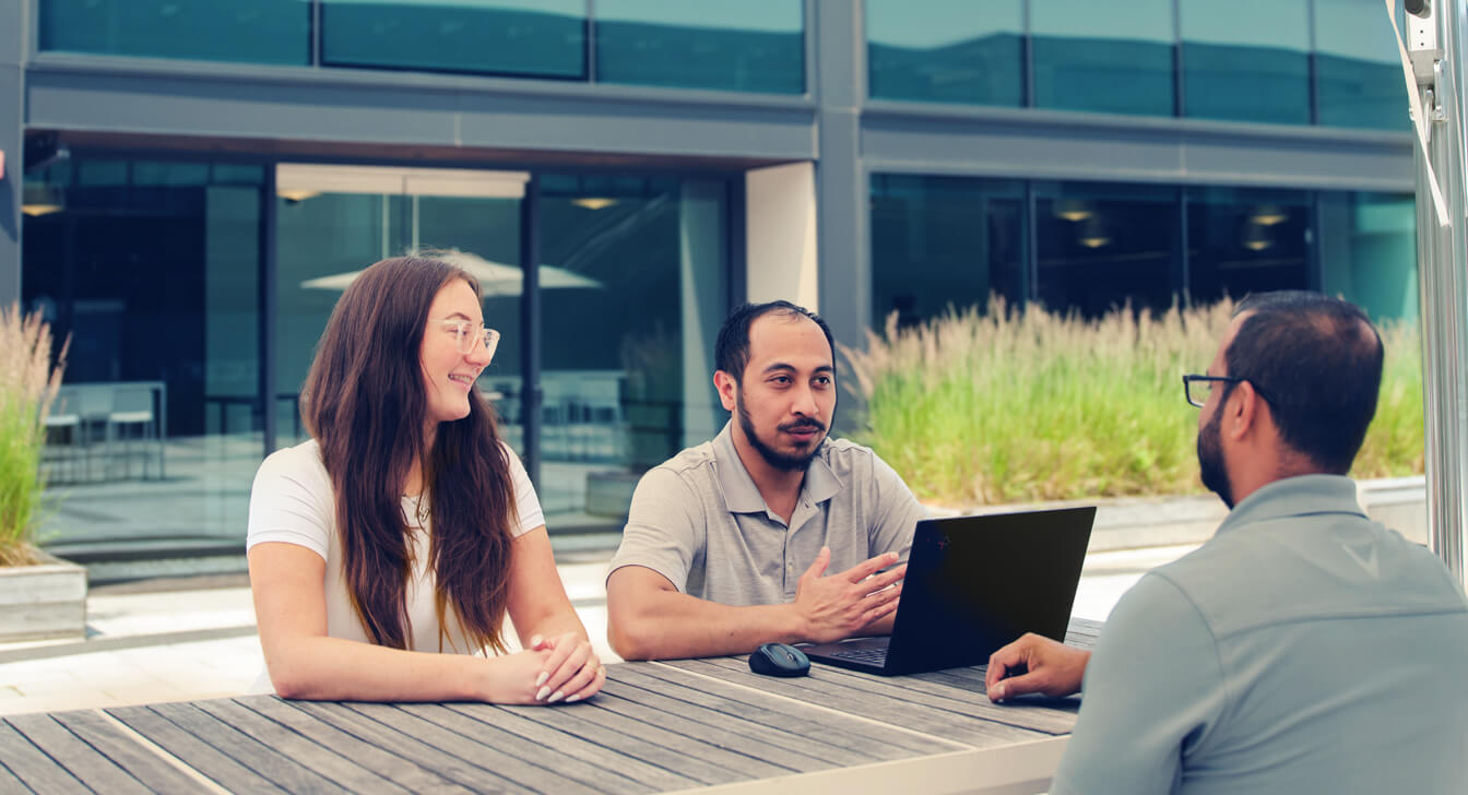 Employees having a discussion at the outdoor patio